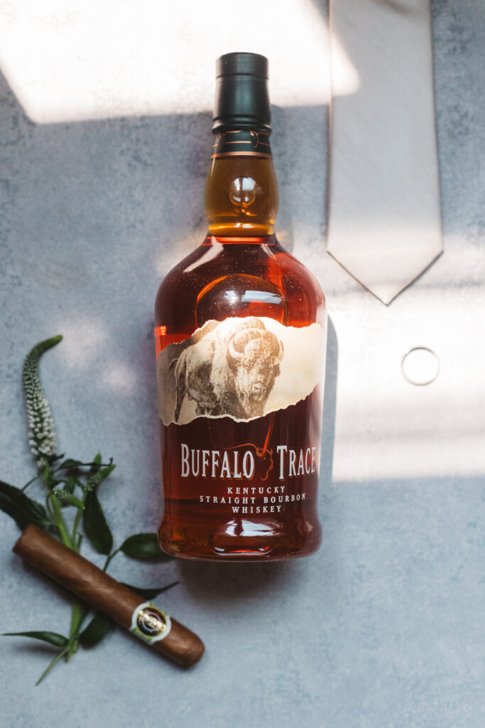 Photo of whiskey and cigar with grooms accessories on this wedding day in Pennsylvania. Taken by east coast wedding photographer Madison Neumann Photography.