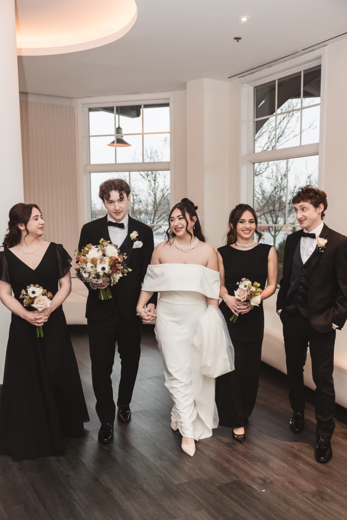 Bride and groom with their wedding party of bridesmaids and groomsmen. Wedding day at Maritime Parc in Jersey City, NJ. Photographed by South Jersey, Philadelphia based wedding photographer Madison Neumann Photography.