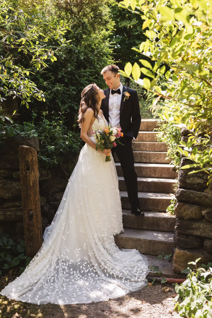 Bridal gown train down garden steps with groom for wedding at Bartram's Garden in Philadelphia, PA. Photographed by South Jersey Philly wedding photographer Madison Neumann Photography.