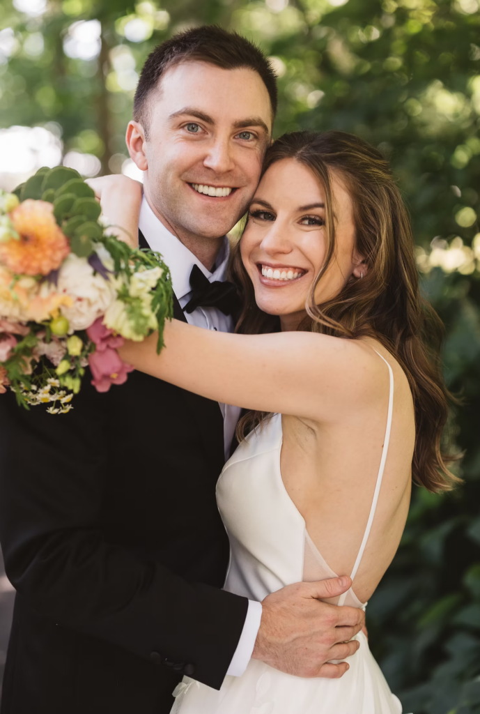 Couples portrait of smiling bride and groom with bouquet for wedding at Bartram's Garden in Philadelphia, PA. Photographed by New Jersey Philly wedding photographer Madison Neumann Photography.