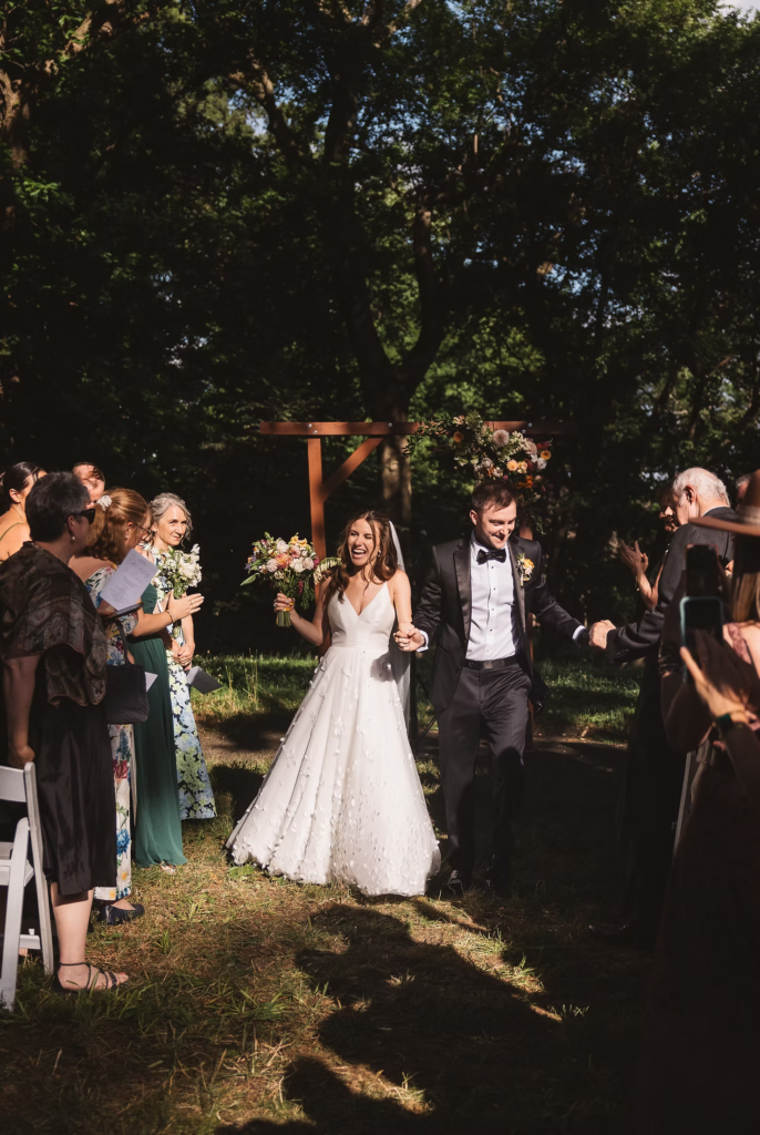 Bride and groom celebrate after outdoor ceremony for wedding at Bartram's Garden in Philadelphia, PA. Photographed by South Jersey Philly wedding photographer Madison Neumann Photography.