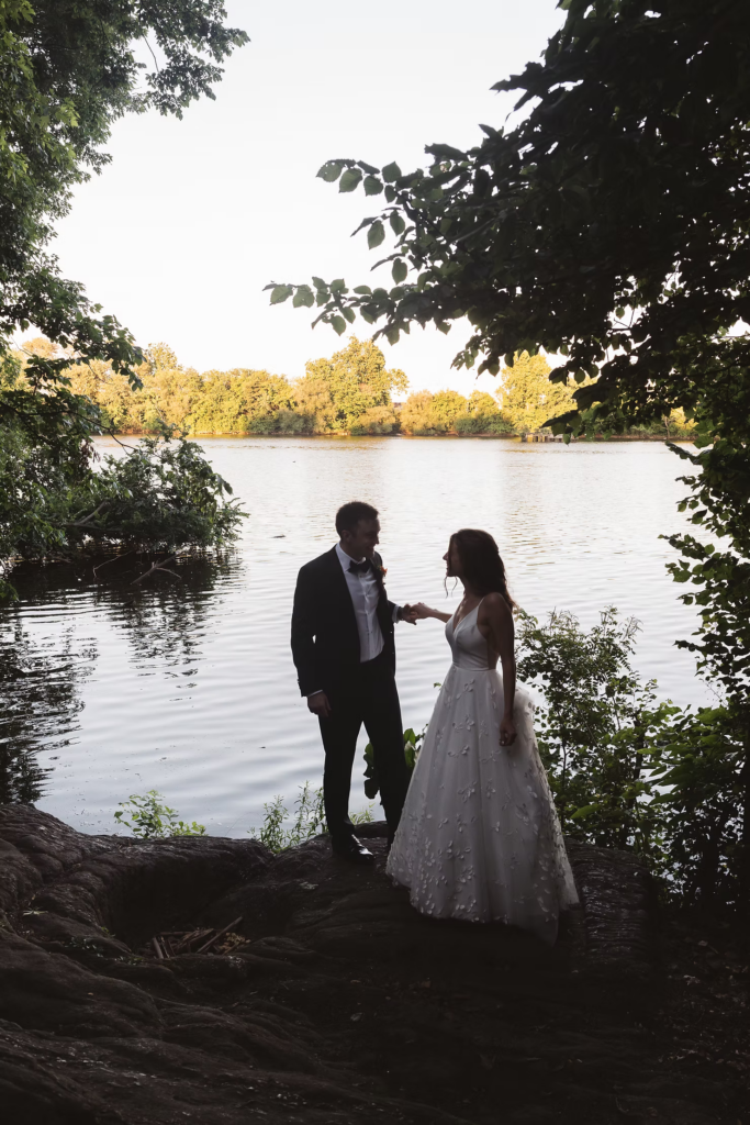 Bride and groom couples portrait by lake with framing trees for wedding at Bartram's Garden in Philadelphia, PA. Photographed by South Jersey Philly wedding photographer Madison Neumann Photography.