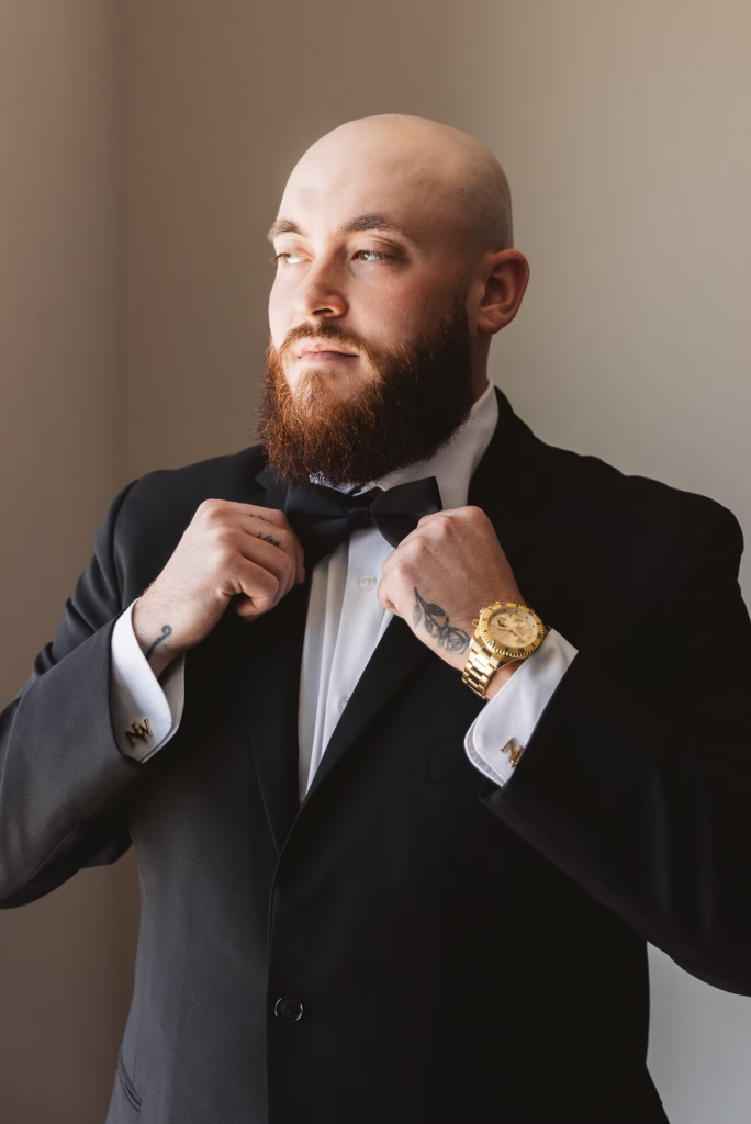 Groom in tuxedo and bowtie with watch for portrait getting ready for wedding day at The Ivy at Ellis Preserve in Newtown Square, PA. Photographed by South Jersey, Pennsylvania region wedding photographer Madison Neumann Photography.