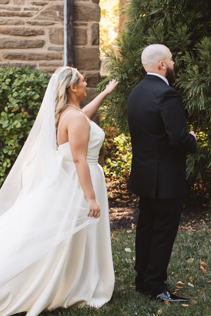 Groom waiting to turn around to see bride in gown and veil for first look moment for wedding day at The Ivy at Ellis Preserve in Newtown Square, PA. Photographed by South Jersey, Pennsylvania region wedding photographer Madison Neumann Photography.