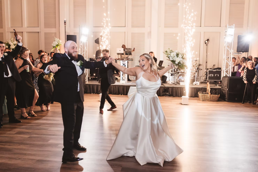 Sparkler fountain on dance floor as newlywed bride and groom share first dance during wedding reception at The Ivy at Ellis Preserve by Finley Catering in Newtown Square, Pennsylvania. Wedding day photographed by NJ/PA region wedding photographer Madison Neumann Photography.