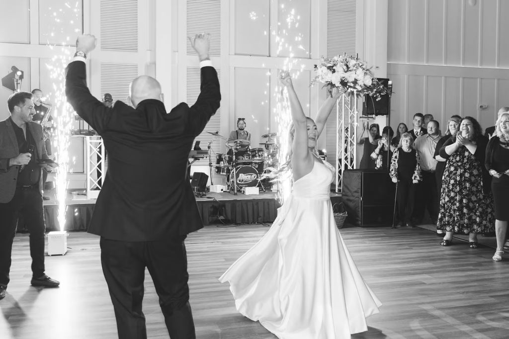Newlywed bride and groom celebrate with guests on dance floor with sparkler fountain for wedding reception at The Ivy at Ellis Preserve by Finley Catering in Newtown Square, PA. Wedding day photographed by South Jersey, Pennsylvania region wedding photographer Madison Neumann Photography.