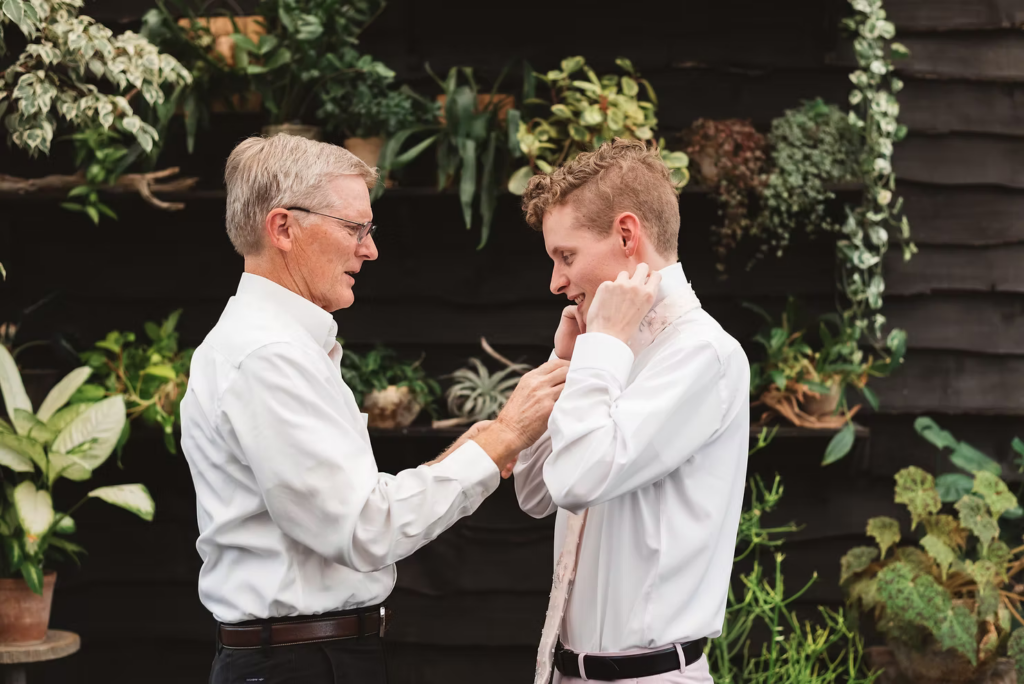 Groom gets ready for his summer garden wedding at terrain in glen mills, PA. photo by Madison Neumann photography.