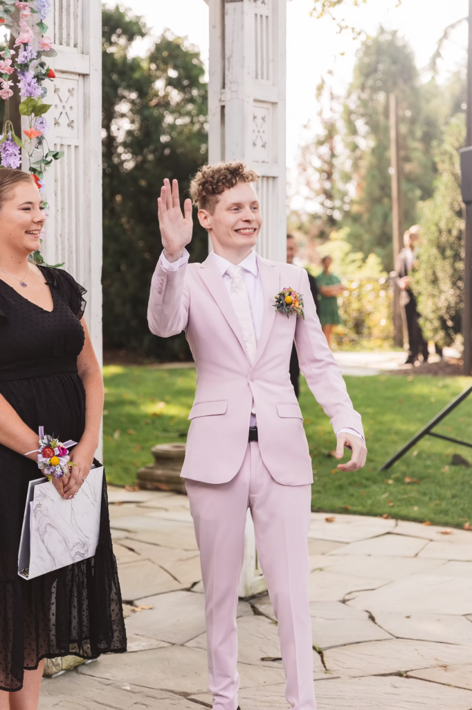 Wedding ceremony at Terrain in Glen Mills, PA. Groom enters and waves. Taken by philly wedding photographer Madison Neumann Photography.