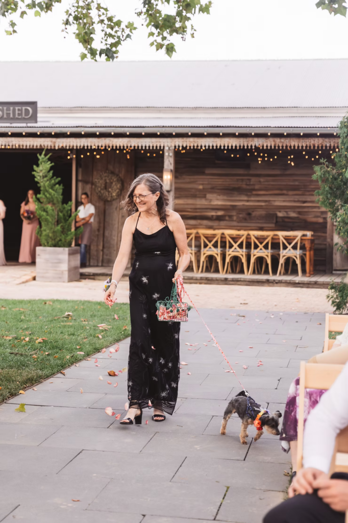 Wedding ceremony at Terrain in Glen Mills, PA. The brides mom walks her dog down the aisle as the flower girl. Taken by philly wedding photographer Madison Neumann Photography.