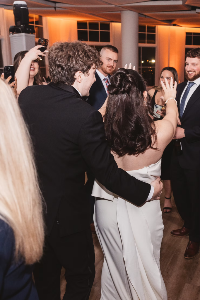 Bride and groom dance with their guests at reception on the dance floor. Wedding day at Maritime Parc in Jersey City, NJ. Photographed by South Jersey, Philadelphia based wedding photographer Madison Neumann Photography.