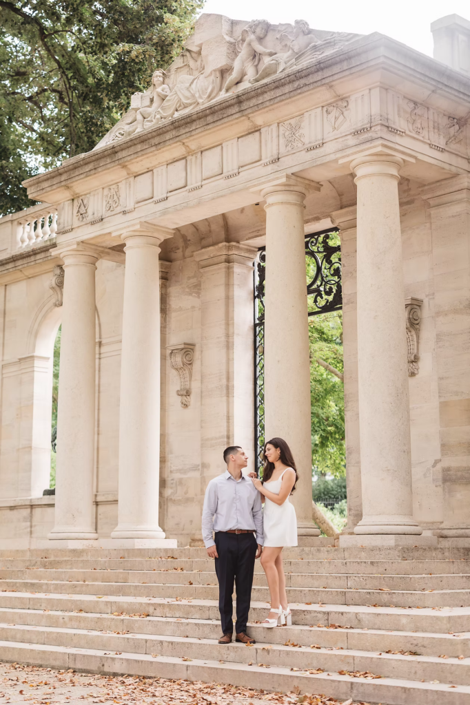 Soon to be bride and groom on steps with pillars and sculpture behind them. Engagement photos at The Rodin Museum in Philadelphia, PA. Photographed by wedding photographer Madison Neumann Photography.