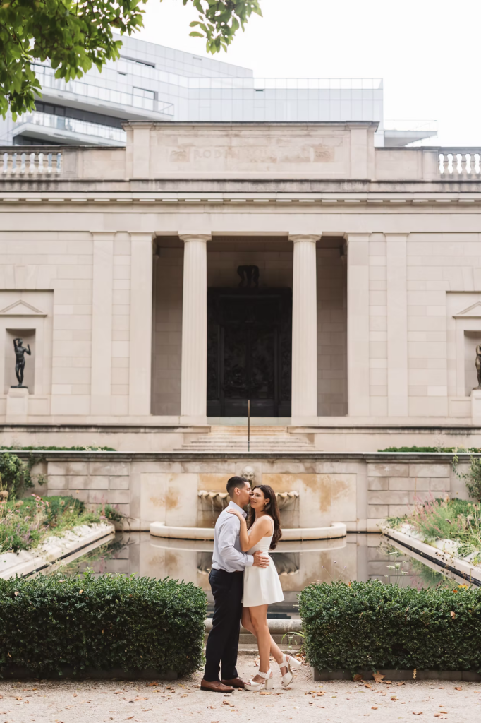 Fiancées smile together for engagement couples portraits in the garden of The Rodin Museum in Philadelphia, PA. Photographed by Philly, South Jersey region wedding photographer Madison Neumann Photography.