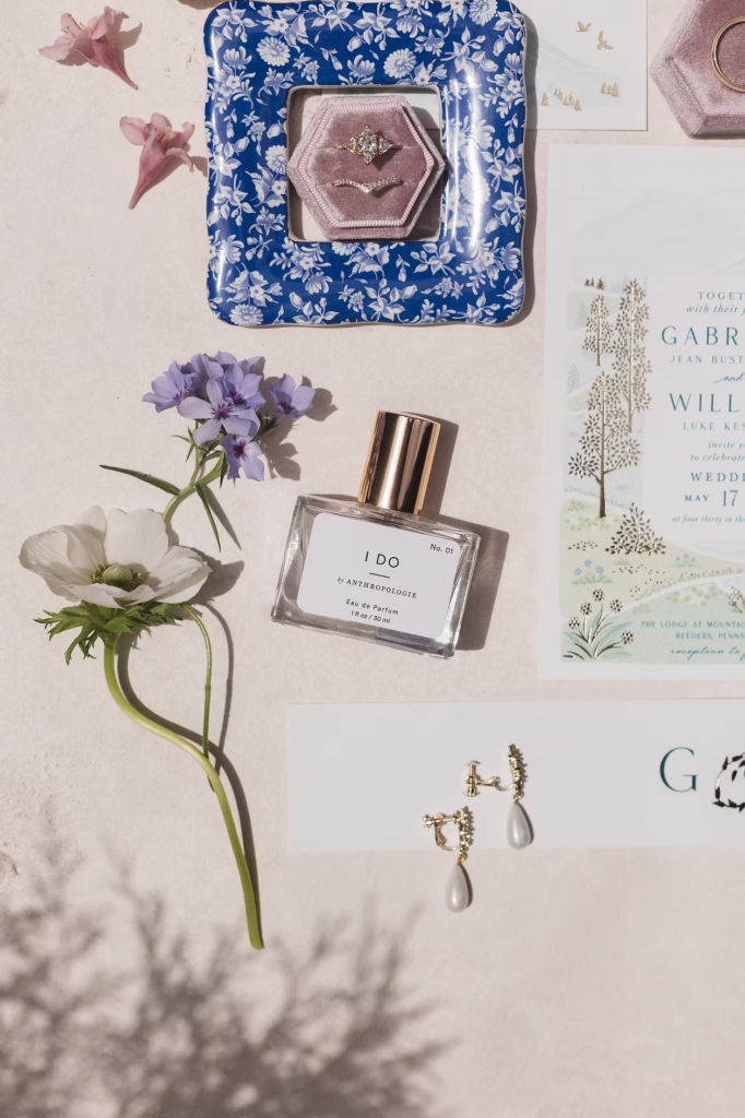 Bridal perfume and jewelry photographed with an invitation suite for a May wedding in the Pocono mountains. Taken by Pennsylvania wedding photographer Madison Neumann Photography.
