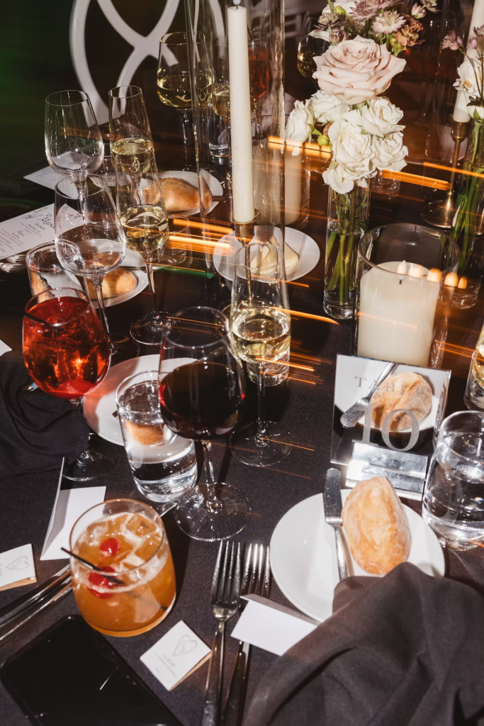 Table at the end of wedding reception with decor and cocktail glasses. Wedding day at Maritime Parc in Jersey City, NJ. Photographed by South Jersey, Philadelphia based wedding photographer Madison Neumann Photography.