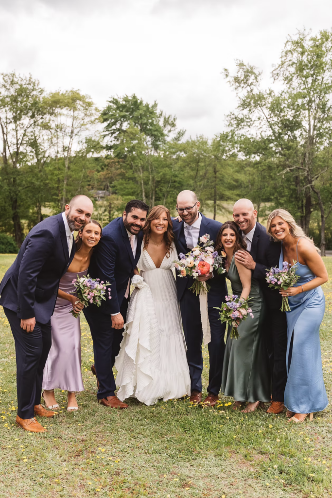 Bride and groom with their wedding party in field for Pennsylvania wedding in the Pocono Mountains. Photographed by South Jersey Philly Wedding Photographer Madison Neumann Photography.