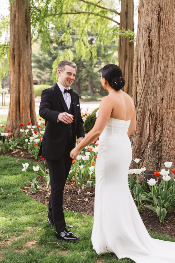 Bride and groom meet outside for their first look, smiling when seeing each other for the first time. Photographed at The Madison Hotel in Morristown, NJ by wedding photographer Madison Neumann Photography.