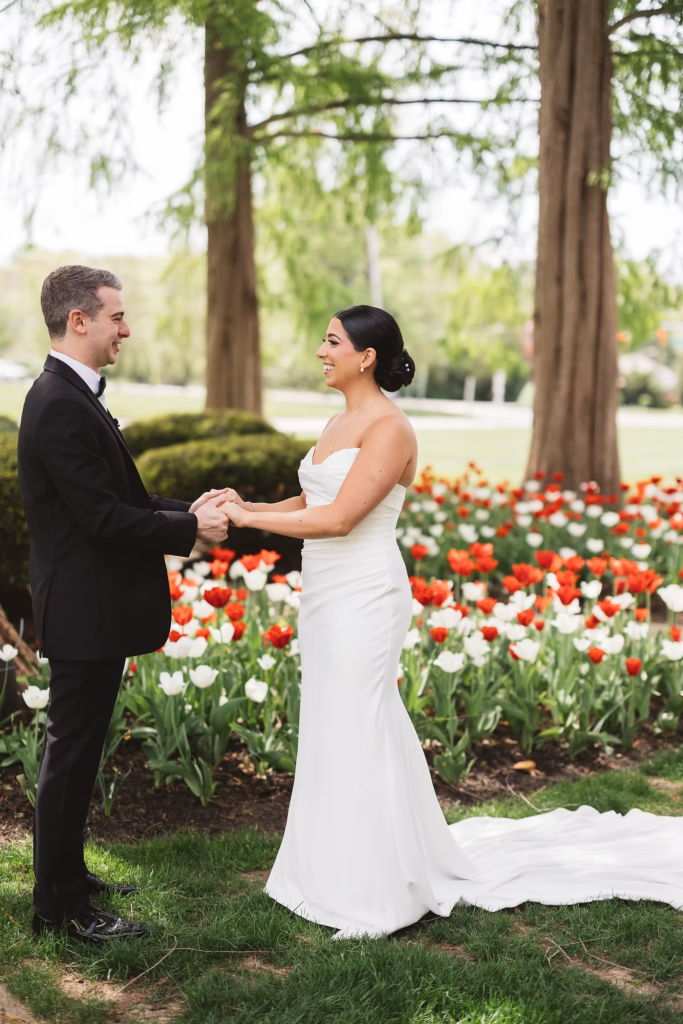 Bride and groom embrace after first look on wedding day with tulips and greenery around them. Photographed at The Madison Hotel in Morristown, NJ by wedding photographer Madison Neumann Photography.