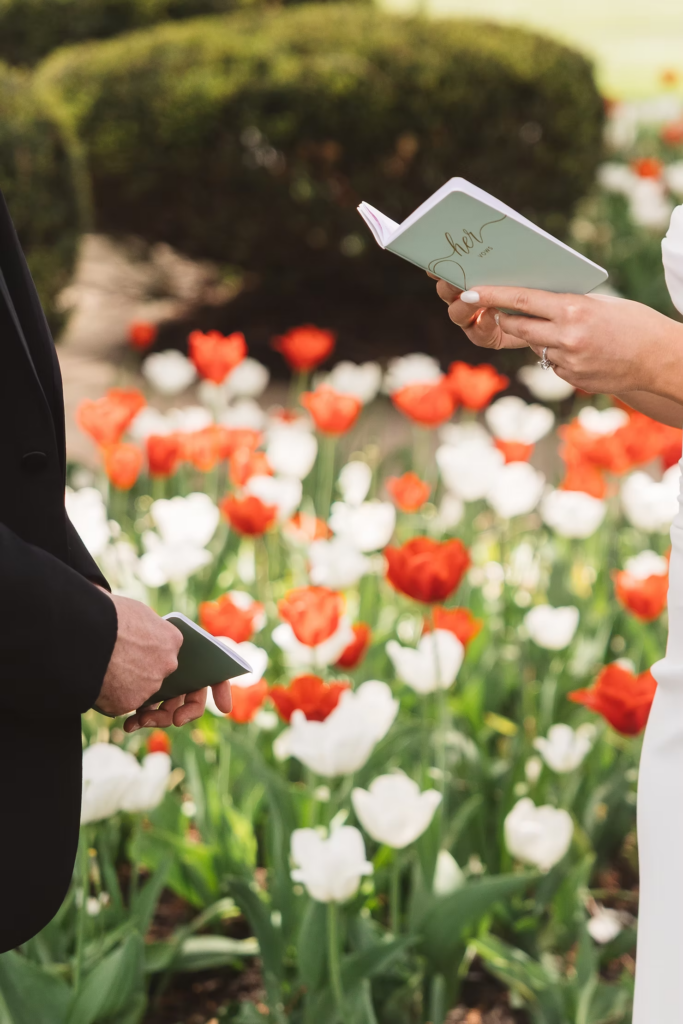 Bride and groom hold their vow booklets as they read their words to one another. Photographed at The Madison Hotel in Morristown, NJ by wedding photographer Madison Neumann Photography.