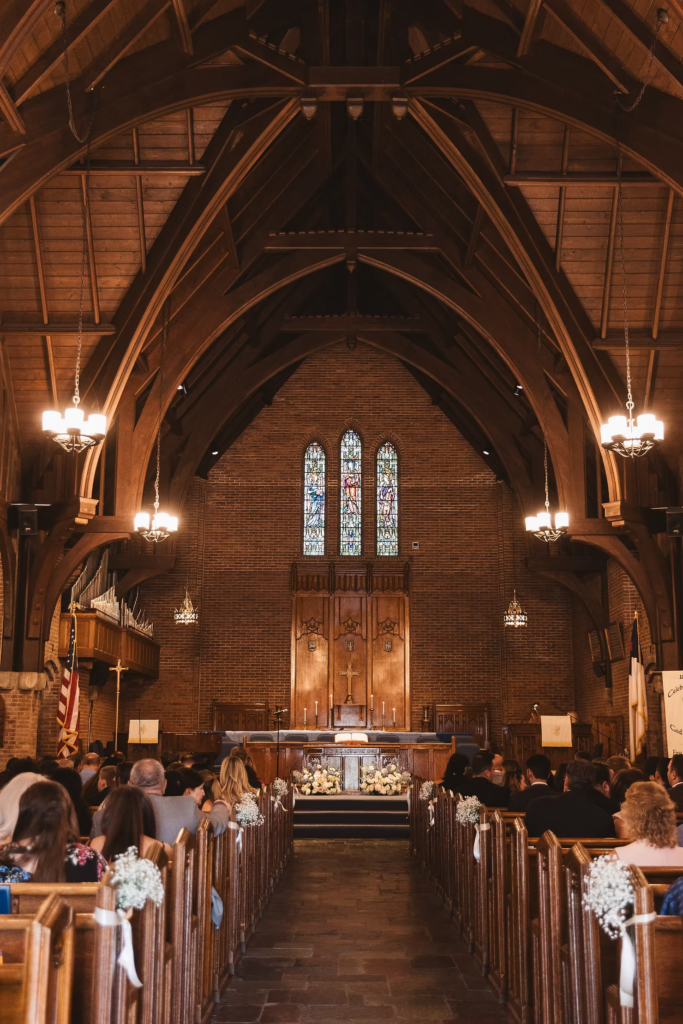Church with high ceilings and stain glass windows where wedding ceremony is being held. Photographed at The Madison Hotel in Morristown, NJ by wedding photographer Madison Neumann Photography.