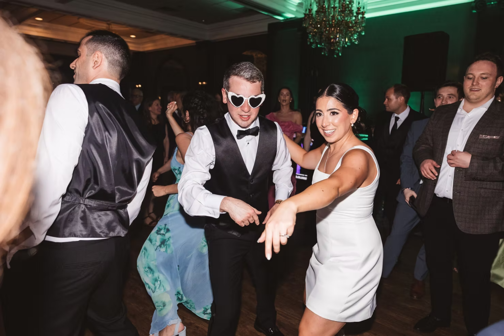 Bride and groom dance with their wedding guests. Photographed at The Madison Hotel in Morristown, NJ by wedding photographer Madison Neumann Photography.