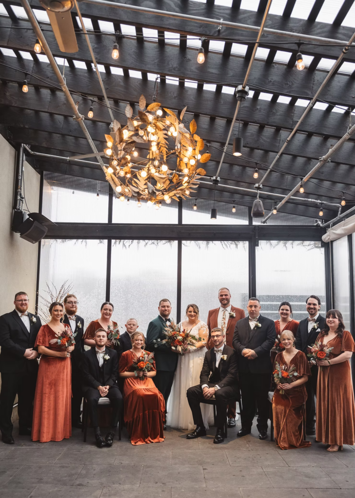 Bride and groom with their wedding party, bridesmaids and groomsmen. Wedding day at Terrain Gardens at DelVal in Doylestown, Pennsylvania. Photographed by South Jersey, Philadelphia based wedding photographer Madison Neumann Photography.