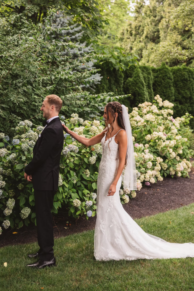Bride and groom get ready for their first look in garden of historic wedding venue for wedding at The William Penn Inn in Gwynedd, PA. Photographed by Pennsylvania South Jersey area wedding photographer Madison Neumann Photography.