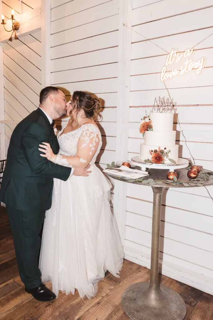 Newlywed bride and groom cut their cake during wedding reception at Terrain Gardens at DelVal in Doylestown, Pennsylvania. Photographed by South Jersey, Philadelphia based wedding photographer Madison Neumann Photography.