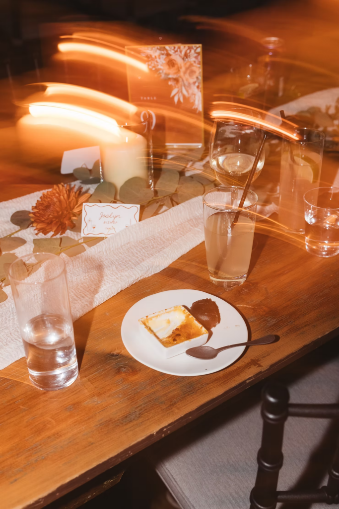 End of the night photograph of table during wedding reception at Terrain Gardens at DelVal in Doylestown, Pennsylvania. Photographed by South Jersey, Philadelphia based wedding photographer Madison Neumann Photography.