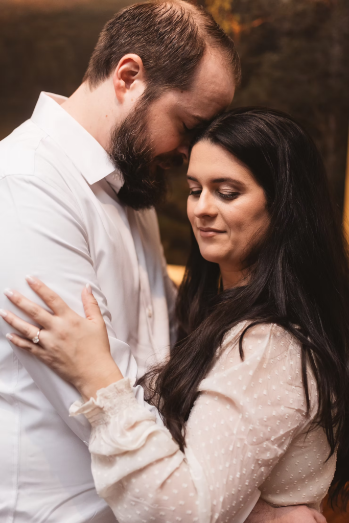 A future bride and groom pose together in front of a painting inside the Pennsylvania Academy of The Fine Arts for their art museum engagement session in Philadelphia. Photographed by Philly wedding photographer Madison Neumann Photography.