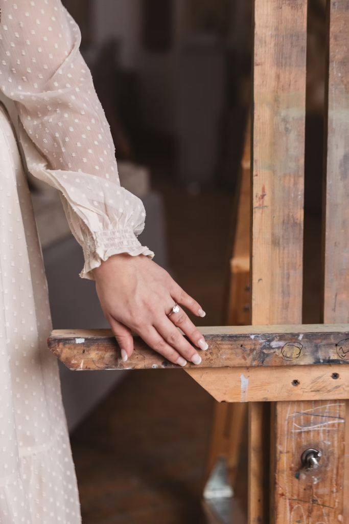 A future bride's hand with her engagement ring touching an art aisle. Photographed at the Pennsylvania Academy of The Fine Arts for art museum engagement session in Philadelphia. Taken by Philly wedding photographer Madison Neumann Photography.
