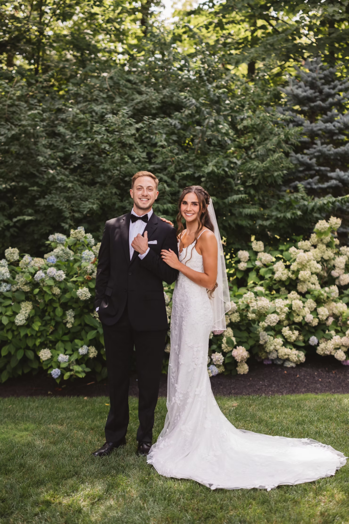 Bride and groom smile for portrait in garden of historic venue for wedding day at The William Penn Inn in Gwynedd, PA. Photographed by Pennsylvania South Jersey area wedding photographer Madison Neumann Photography.