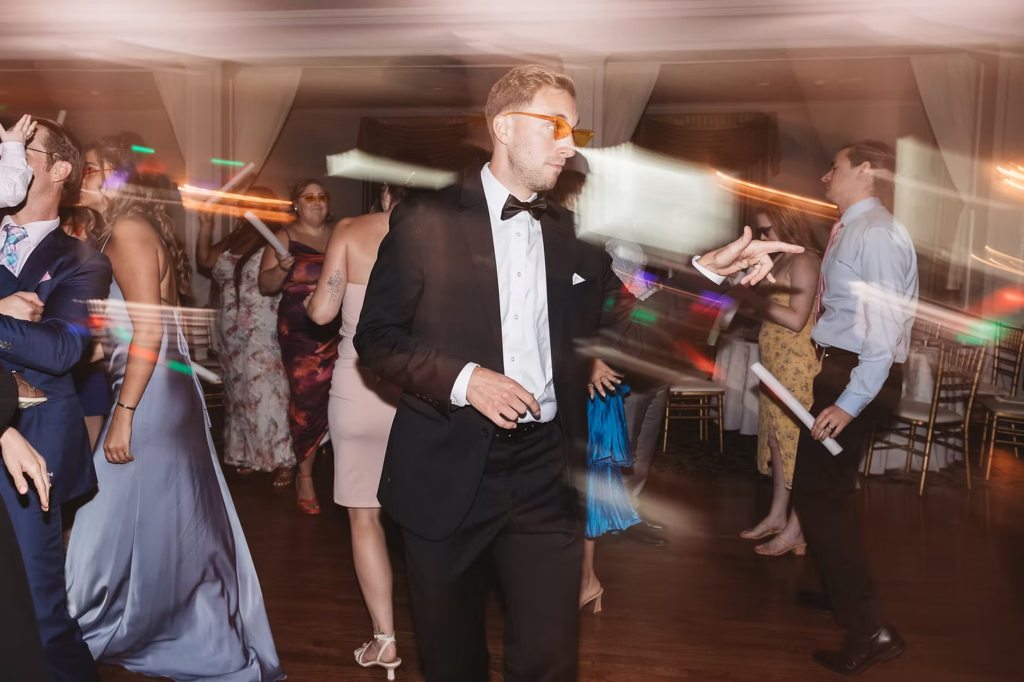 Groom on dance floor with sunglasses for fun photo at wedding at The William Penn Inn in Gwynedd, PA. Photographed by Pennsylvania South Jersey area wedding photographer Madison Neumann Photography.