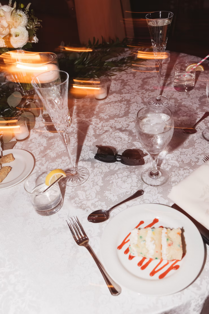 Nighttime detail photo of table decor and cake for wedding day at The William Penn Inn in Gwynedd, PA. Photographed by Pennsylvania South Jersey area wedding photographer Madison Neumann Photography.