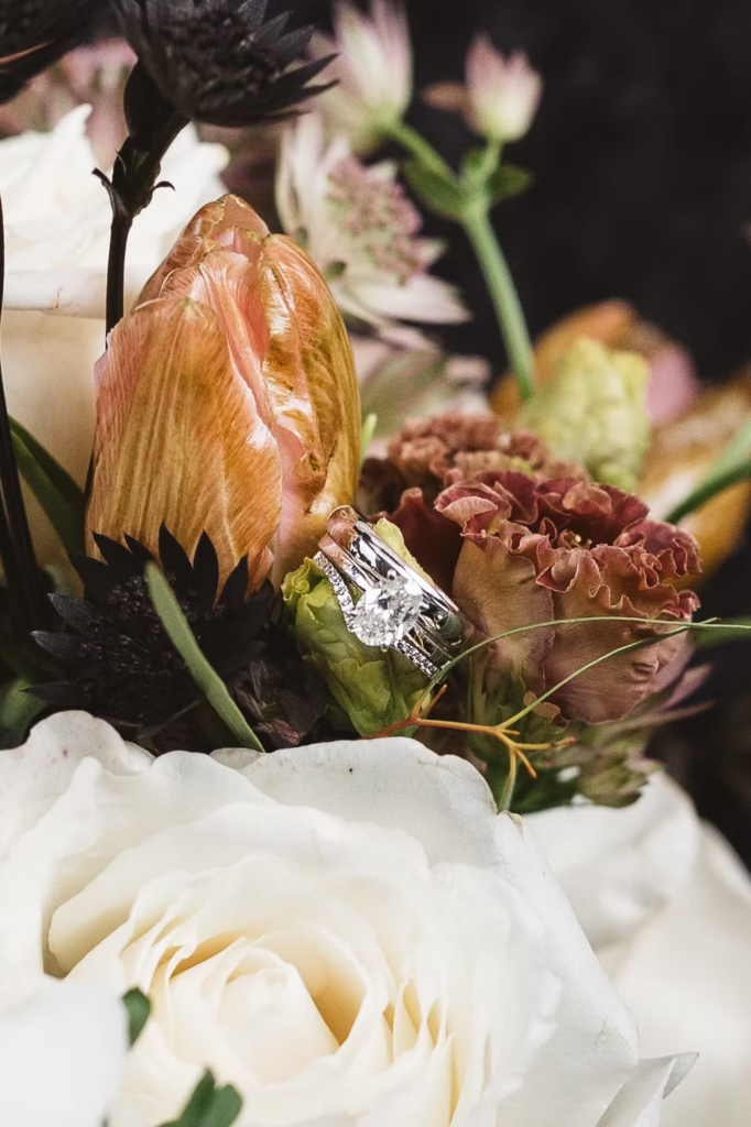 Close ups of bouquet of flowers with wedding rings intertwined. Wedding day at Maritime Parc in Jersey City, NJ. Photographed by South Jersey, Philadelphia based wedding photographer Madison Neumann Photography.