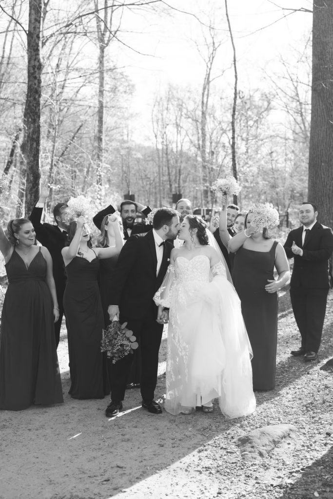 Bride and groom celebrate with their wedding party, bridesmaids and groomsmen, for portraits in the park. Wedding day photographed at David's Country Inn in Hackettstown, NJ by South Jersey, Philadelphia based wedding photographer Madison Neumann Photography.