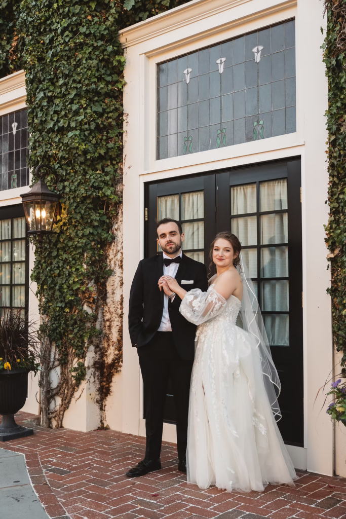 Ivy on walls of historic venue, stained glass windows, bride and groom outside David's Country Inn in Hackettstown, NJ on their wedding day. Photographed by South Jersey, Philadelphia based wedding photographer Madison Neumann Photography.