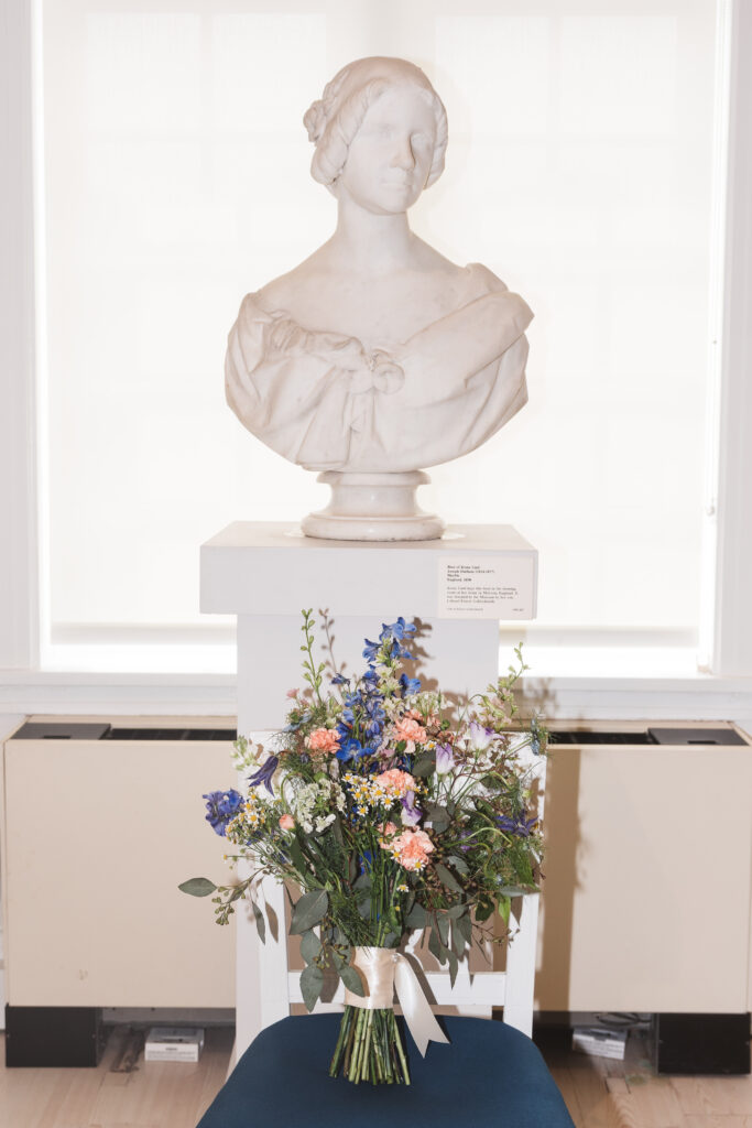 Sculpture bust of woman, bouquet of wedding flowers next to it. Wedding day at the American Swedish Historical Museum in Philadelphia, PA. Photographed by South Jersey/Philly based wedding photographer Madison Neumann Photography.