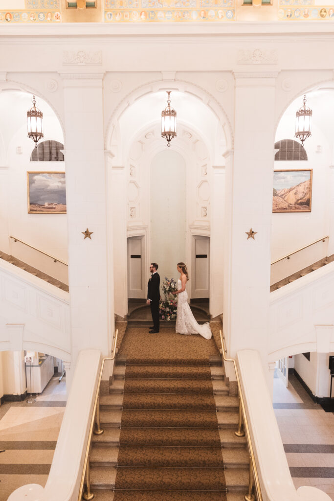 Bride stands behind groom, waiting for him to turn around for their first look. Wedding day at the American Swedish Historical Museum in Philadelphia, PA. Photographed by South Jersey/Philly based wedding photographer Madison Neumann Photography.