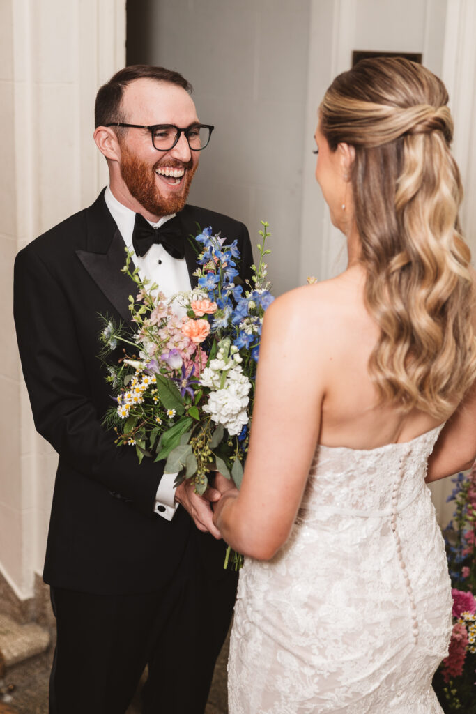 Groom is smiling seeing his bride for the first time on their wedding day. Wedding day at the American Swedish Historical Museum in Philadelphia, PA. Photographed by South Jersey/Philly based wedding photographer Madison Neumann Photography.