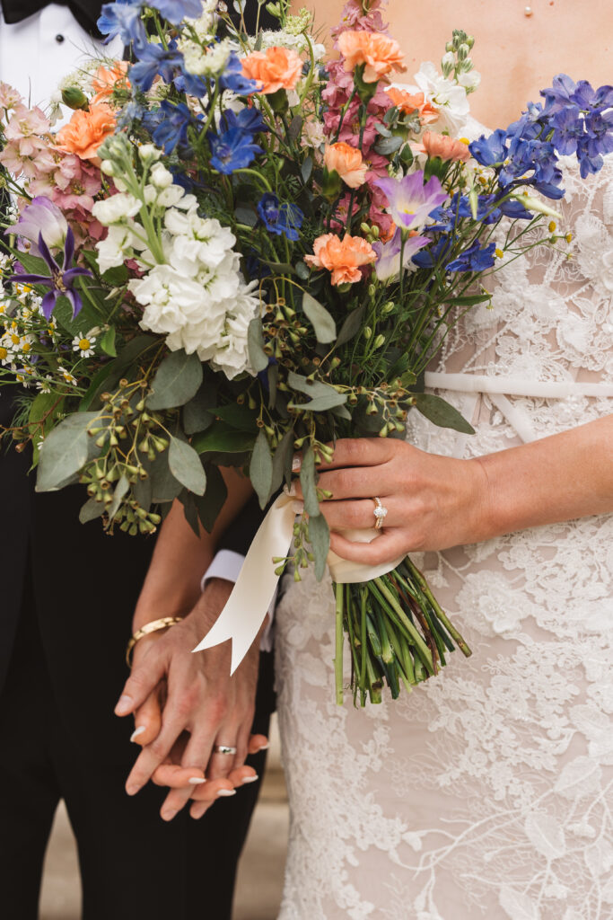 Close up of bride and groom holding hands, bride holding bouquet in other hand. Wedding day at the American Swedish Historical Museum in Philadelphia, PA. Photographed by South Jersey/Philly based wedding photographer Madison Neumann Photography.