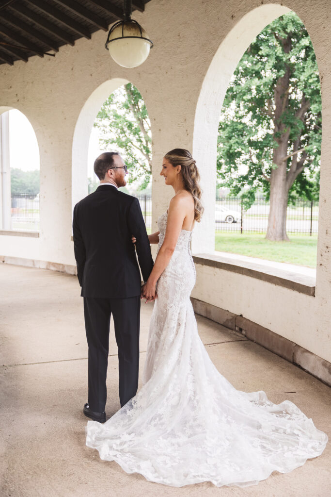 Bride and groom hold hands and walk together outside venue. Wedding day at the American Swedish Historical Museum in Philadelphia, PA. Photographed by South Jersey/Philly based wedding photographer Madison Neumann Photography.