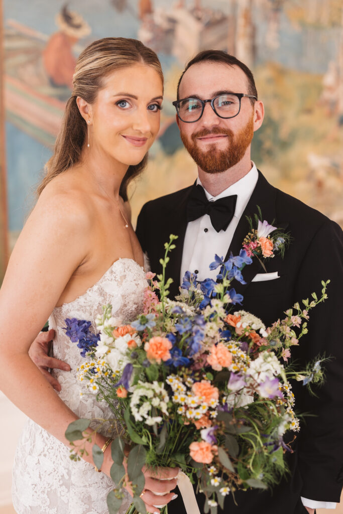 Portrait of bride and groom in front of painting at their museum wedding venue. Wedding day at the American Swedish Historical Museum in Philadelphia, PA. Photographed by South Jersey/Philly based wedding photographer Madison Neumann Photography.