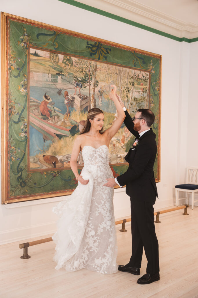 Bride and groom dance together in front of art at museum wedding venue. Wedding day at the American Swedish Historical Museum in Philadelphia, PA. Photographed by South Jersey/Philly based wedding photographer Madison Neumann Photography.