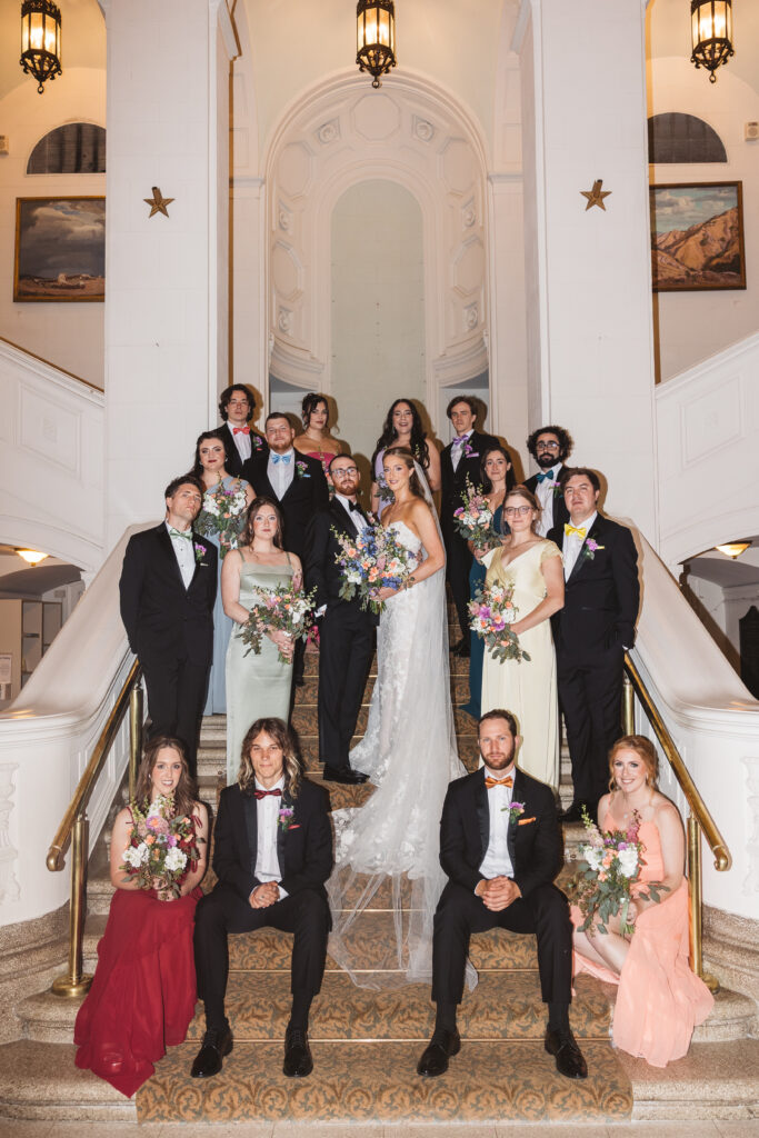 Bride and groom with their wedding party on the steps of their ceremony space. Wedding day at the American Swedish Historical Museum in Philadelphia, PA. Photographed by South Jersey/Philly based wedding photographer Madison Neumann Photography.