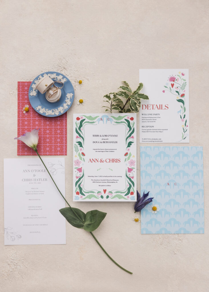Flat lay photograph of wedding details including colorful invitation suite, flowers, and rings. Wedding day at the American Swedish Historical Museum in Philadelphia, PA. Photographed by South Jersey/Philly based wedding photographer Madison Neumann Photography.