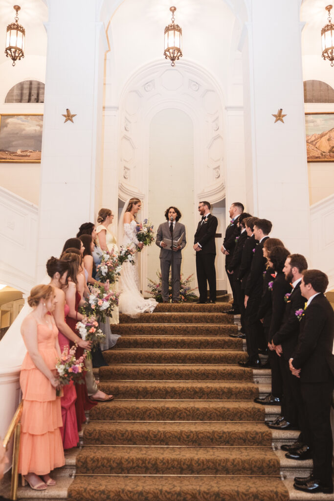 Bride and groom at the altar together at the top of the steps of their ceremony. Wedding day at the American Swedish Historical Museum in Philadelphia, PA. Photographed by South Jersey/Philly based wedding photographer Madison Neumann Photography.
