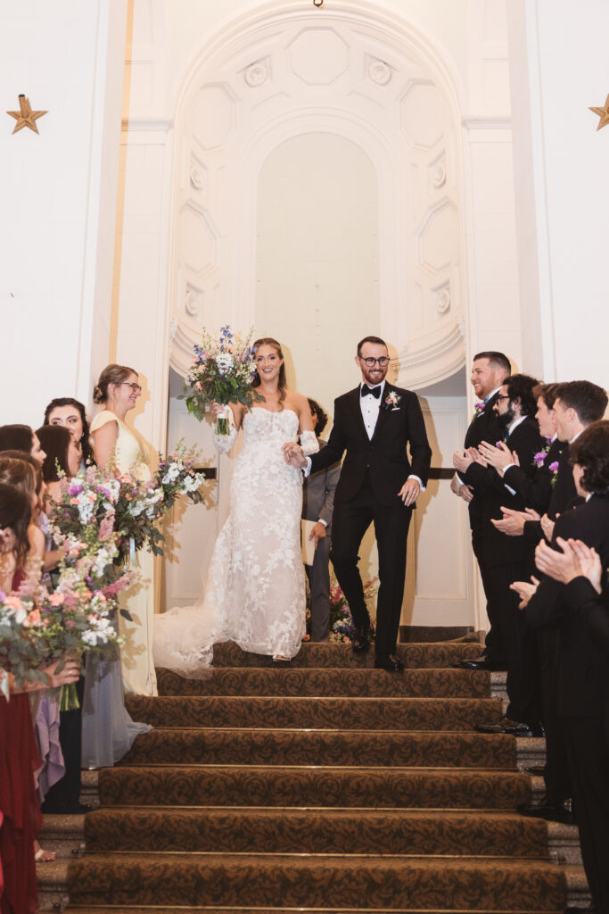Newlywed bride and groom walk together down the steps after ceremony. Wedding day at the American Swedish Historical Museum in Philadelphia, PA. Photographed by South Jersey/Philly based wedding photographer Madison Neumann Photography.
