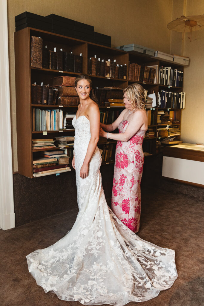 Bride's mother helps get bride ready in her gown. Wedding day at the American Swedish Historical Museum in Philadelphia, PA. Photographed by South Jersey/Philly based wedding photographer Madison Neumann Photography.