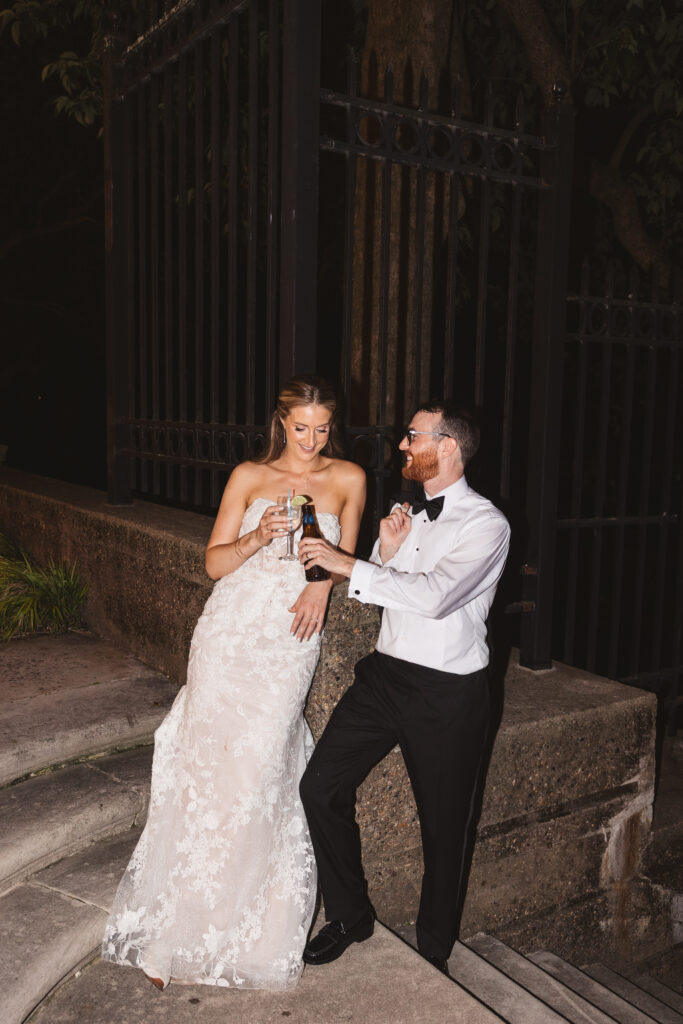 Bride and groom cheers with drinks outside at the end of their wedding night. Wedding day at the American Swedish Historical Museum in Philadelphia, PA. Photographed by South Jersey/Philly based wedding photographer Madison Neumann Photography.
