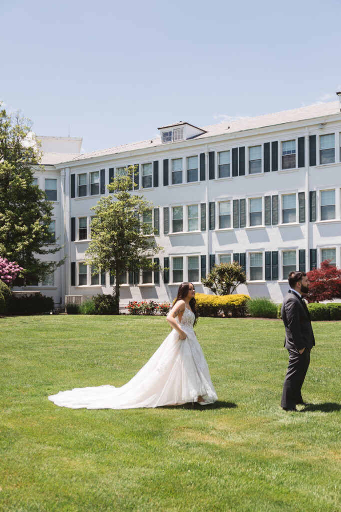 Bride approaches groom outside wedding venue for their first look. Wedding day at Blue Heron Pines Golf Club in Egg Harbor, NJ. Photographed by South Jersey/Philly based wedding photographer Madison Neumann Photography.